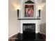 Elegant fireplace with mantle and decorative painting above at 9706 E Sheena Dr, Scottsdale, AZ 85260