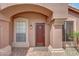 Close-up of front door with sidelight windows and desert landscaping at 9706 E Sheena Dr, Scottsdale, AZ 85260