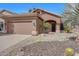 Charming single-story home with desert landscaping, arched entry, and a two-car garage at 9706 E Sheena Dr, Scottsdale, AZ 85260