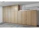 Spacious garage featuring built-in wood cabinets for organizing and storage at 9706 E Sheena Dr, Scottsdale, AZ 85260