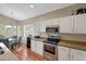Modern kitchen features stainless steel appliances, granite countertops, and breakfast nook at 9706 E Sheena Dr, Scottsdale, AZ 85260