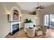 Cozy living room with fireplace, comfortable seating, and seamless patio access at 9706 E Sheena Dr, Scottsdale, AZ 85260