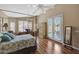 Relaxing main bedroom features a four-poster bed, neutral decor, and outdoor access at 9706 E Sheena Dr, Scottsdale, AZ 85260