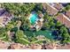 Stunning aerial view showcases a sparkling community pool and serene pond with lush landscaping at 10015 E Mountain View Rd # 2010, Scottsdale, AZ 85258