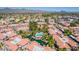 A lush aerial view reveals a community pool surrounded by mature landscaping and well-maintained buildings at 10015 E Mountain View Rd # 2010, Scottsdale, AZ 85258