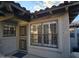 Charming condo exterior showcases shuttered windows, security door, and inviting entrance with unit number at 10015 E Mountain View Rd # 2010, Scottsdale, AZ 85258