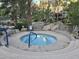 Relaxing community hot tub with tiled accents and convenient access handrails surrounded by lush landscaping at 10015 E Mountain View Rd # 2010, Scottsdale, AZ 85258
