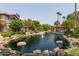 View of a beautiful pond with fountain and lush landscaping, set amongst the community buildings at 10015 E Mountain View Rd # 2010, Scottsdale, AZ 85258