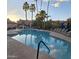 Refreshing community pool with lounge chairs, umbrellas, and lush palm trees for a resort-style experience at 10015 E Mountain View Rd # 2010, Scottsdale, AZ 85258