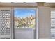 Attractive view of the community through the plantation shutters on the balcony door at 10015 E Mountain View Rd # 2010, Scottsdale, AZ 85258