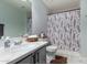 Bright bathroom with a shower, marble floors, decorative shower curtain, and modern fixtures at 10865 E Florian Ave, Mesa, AZ 85208