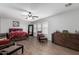 Bright bedroom with wood-look flooring, ceiling fan, and large windows for plenty of natural light at 10865 E Florian Ave, Mesa, AZ 85208