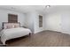 Bright bedroom with wood floors, a comfy bed, and sliding closet doors at 10865 E Florian Ave, Mesa, AZ 85208