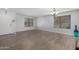 Bright and airy living space featuring neutral walls, wood-look tile flooring, and a window with blinds at 10865 E Florian Ave, Mesa, AZ 85208