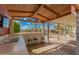 Entertain in this fabulous outdoor kitchen with a bar, sink, stools, and pool access at 10865 E Florian Ave, Mesa, AZ 85208