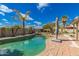 Backyard Oasis featuring a refreshing pool and tropical landscaping at 10865 E Florian Ave, Mesa, AZ 85208