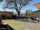 Large backyard with partial grass, nice views and secure fencing, creating a perfect outdoor oasis at 10980 E Winchcomb Dr, Scottsdale, AZ 85255