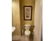 Cozy powder room with textured walls and artwork at 10980 E Winchcomb Dr, Scottsdale, AZ 85255