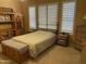 Inviting bedroom features a king bed, wood furniture, and ample natural light from large shuttered windows at 10980 E Winchcomb Dr, Scottsdale, AZ 85255