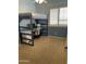 room features a loft bed with a desk underneath and natural light from a large shuttered window at 10980 E Winchcomb Dr, Scottsdale, AZ 85255