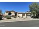 Attractive single-story home with desert landscaping including cacti, a three-car garage, and a tile roof at 10980 E Winchcomb Dr, Scottsdale, AZ 85255