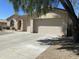 Lovely single-story home boasting a three-car garage and desert landscaping on a sunny day at 10980 E Winchcomb Dr, Scottsdale, AZ 85255