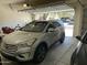 Neatly arranged garage featuring two parked cars and open door at 10980 E Winchcomb Dr, Scottsdale, AZ 85255