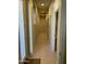 Long hallway with tiled flooring and a stone accent wall feature at 10980 E Winchcomb Dr, Scottsdale, AZ 85255