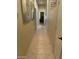 Hallway with tiled floor, artwork, and views into adjoining rooms at 10980 E Winchcomb Dr, Scottsdale, AZ 85255