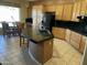 Stylish kitchen island with seating, granite counters, and modern appliances, ideal for casual dining and meal prep at 10980 E Winchcomb Dr, Scottsdale, AZ 85255