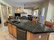 Gourmet kitchen island with granite countertops, stainless steel appliances, and seating, perfect for entertaining at 10980 E Winchcomb Dr, Scottsdale, AZ 85255