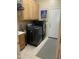 Functional laundry room equipped with modern washer, dryer, sink, and storage cabinets at 10980 E Winchcomb Dr, Scottsdale, AZ 85255
