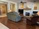 Relaxing living room showcasing fireplace and stone accent wall with a wooden mantle at 10980 E Winchcomb Dr, Scottsdale, AZ 85255