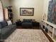 Comfortable living room with a gray sofa, area rug, and modern decor at 10980 E Winchcomb Dr, Scottsdale, AZ 85255