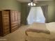 Serene main bedroom with light-colored walls and carpet, complemented by wood furniture at 10980 E Winchcomb Dr, Scottsdale, AZ 85255