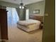 Bright main bedroom offers ample space, carpeted floors, and sliding glass door to patio at 10980 E Winchcomb Dr, Scottsdale, AZ 85255