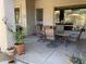 Outdoor dining area on a covered patio with lush greenery at 10980 E Winchcomb Dr, Scottsdale, AZ 85255