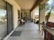 Spacious covered patio with outdoor seating, grill, and access to the backyard at 10980 E Winchcomb Dr, Scottsdale, AZ 85255