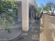 Exterior view of a covered patio with a grill and desert landscaping at 10980 E Winchcomb Dr, Scottsdale, AZ 85255