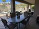 Covered patio with dining area overlooking a fenced pool and desert landscape at 10980 E Winchcomb Dr, Scottsdale, AZ 85255