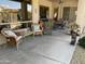 Covered patio with wicker furniture, potted plants, and ceiling fan offering a relaxing outdoor space at 10980 E Winchcomb Dr, Scottsdale, AZ 85255