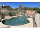 Private swimming pool, perfect for hot days, with desert landscaping and a sports area at 10980 E Winchcomb Dr, Scottsdale, AZ 85255