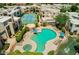 Scenic aerial view of community pool, hot tub, tennis court, lounge chairs, and desert landscaping at 11260 N 92Nd St # 2023, Scottsdale, AZ 85260