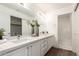 Bathroom featuring a double vanity with white cabinets and a separate shower/tub area at 11260 N 92Nd St # 2023, Scottsdale, AZ 85260