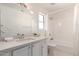 Bright bathroom featuring a large vanity, sink, mirror and a shower-tub combination at 11260 N 92Nd St # 2023, Scottsdale, AZ 85260
