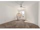 Neutral bedroom showcasing a window, ceiling fan, and charming wicker chair at 11260 N 92Nd St # 2023, Scottsdale, AZ 85260