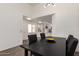 A dining area featuring a dark wood table with gray upholstered chairs and modern lighting at 11260 N 92Nd St # 2023, Scottsdale, AZ 85260