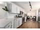 Bright kitchen boasts sleek white cabinets, quartz countertops, modern appliances and wood-look floors at 11260 N 92Nd St # 2023, Scottsdale, AZ 85260