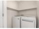 Neat laundry room showcasing modern, white, side-by-side washer and dryer units at 11260 N 92Nd St # 2023, Scottsdale, AZ 85260