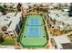 Overhead view of the tennis court, surrounded by lush, desert landscaping and multiple residential buildings at 11260 N 92Nd St # 2023, Scottsdale, AZ 85260